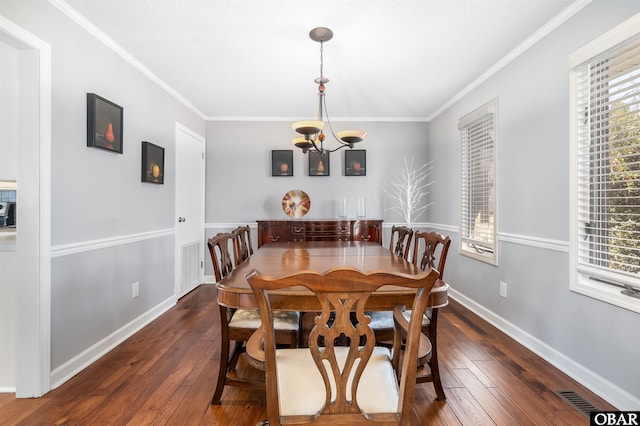 dining room with visible vents, ornamental molding, and wood-type flooring