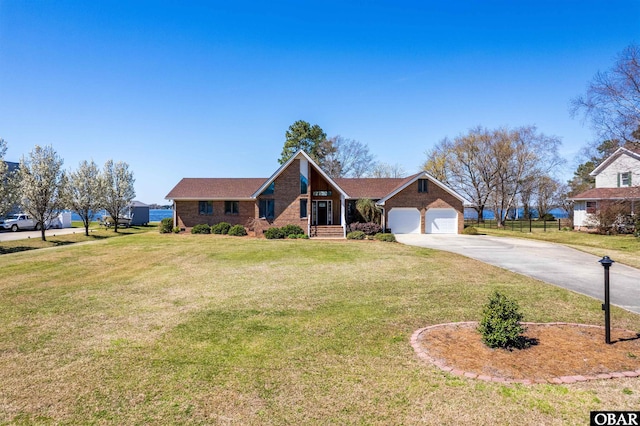 ranch-style house featuring brick siding, a front yard, driveway, and a garage