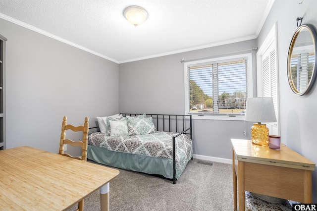 bedroom with baseboards, ornamental molding, visible vents, and carpet