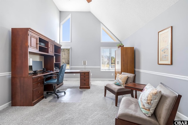 carpeted office featuring high vaulted ceiling, baseboards, and ceiling fan