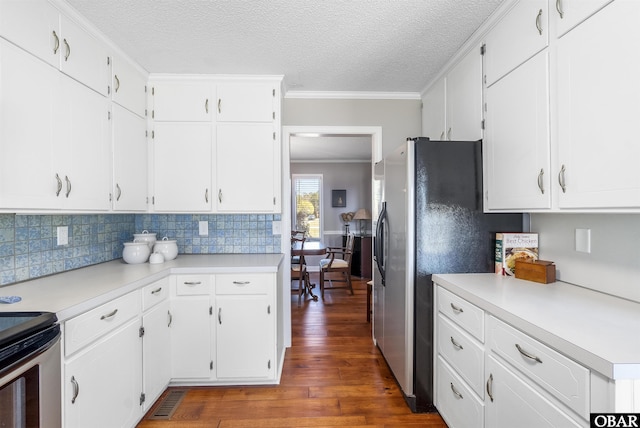 kitchen featuring dark wood finished floors, light countertops, and ornamental molding