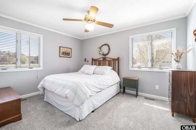 bedroom with light carpet, crown molding, and baseboards