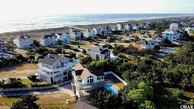 drone / aerial view featuring a beach view and a water view