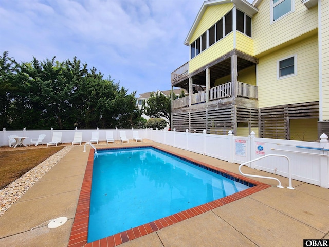 view of swimming pool featuring a fenced in pool and fence