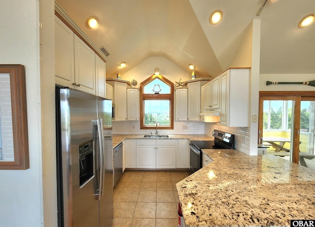 kitchen with decorative backsplash, a sink, stainless steel appliances, and a healthy amount of sunlight