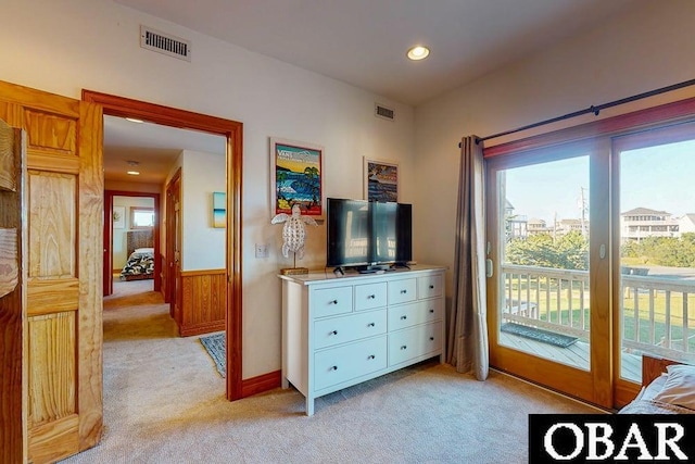 bedroom with recessed lighting, a wainscoted wall, access to exterior, visible vents, and light carpet