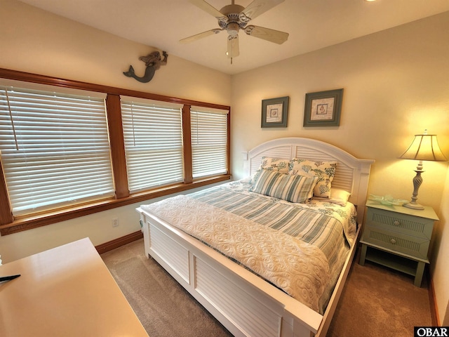 bedroom with ceiling fan, carpet flooring, and baseboards