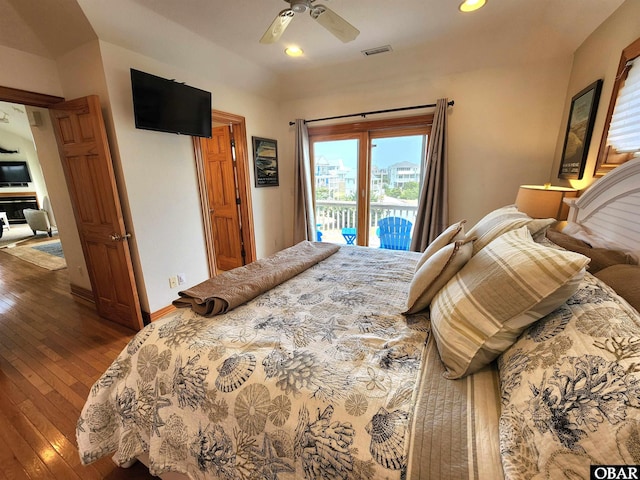bedroom featuring visible vents, baseboards, wood-type flooring, recessed lighting, and access to outside