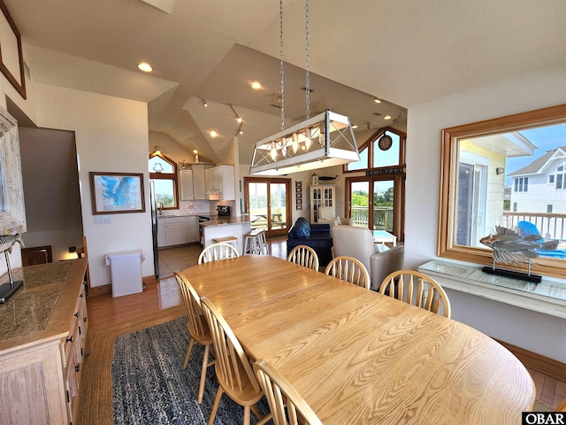 dining area featuring baseboards, recessed lighting, light wood-style flooring, and lofted ceiling