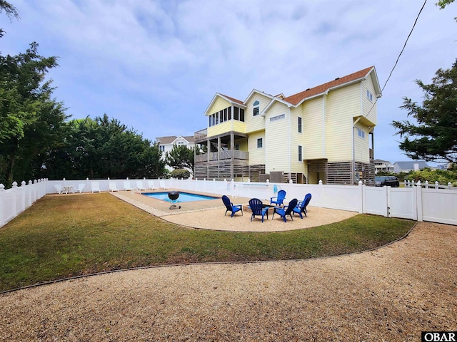 view of pool with a patio area, a fenced backyard, a fenced in pool, and a lawn