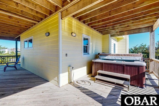 wooden deck featuring a hot tub