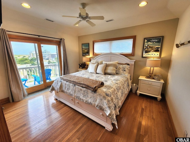bedroom featuring visible vents, access to outside, multiple windows, and wood-type flooring