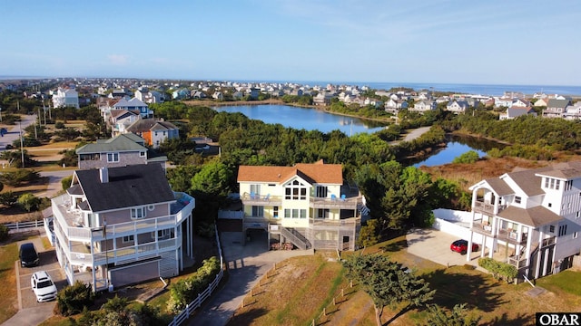 drone / aerial view with a residential view and a water view