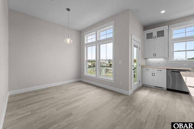 902 S Virginia Dare Trl Unit 703, Kill Devil Hills, NC 27948 - kitchen featuring stainless steel dishwasher, light wood-style flooring, light countertops, baseboards, and recessed lighting