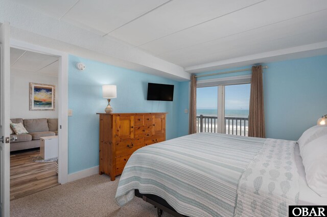 8123 S Old Oregon Inlet Rd Unit 208, Nags Head, NC 27959 - carpeted bedroom featuring access to outside and baseboards