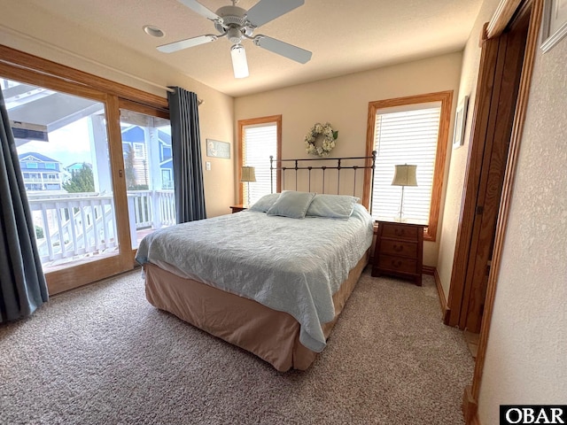 bedroom featuring ceiling fan, light colored carpet, and access to exterior