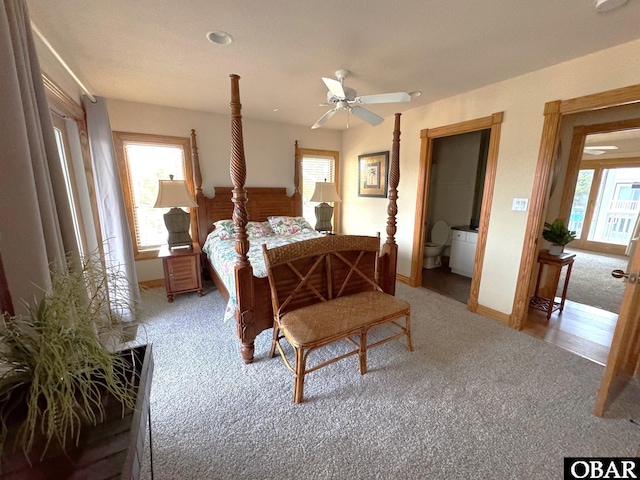 carpeted bedroom with multiple windows and baseboards