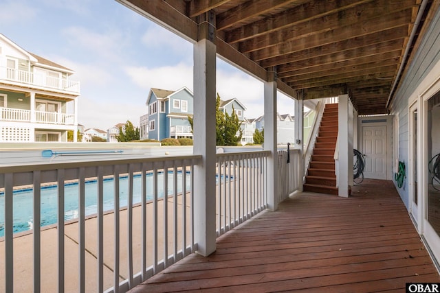 deck with stairs, a residential view, and a fenced in pool