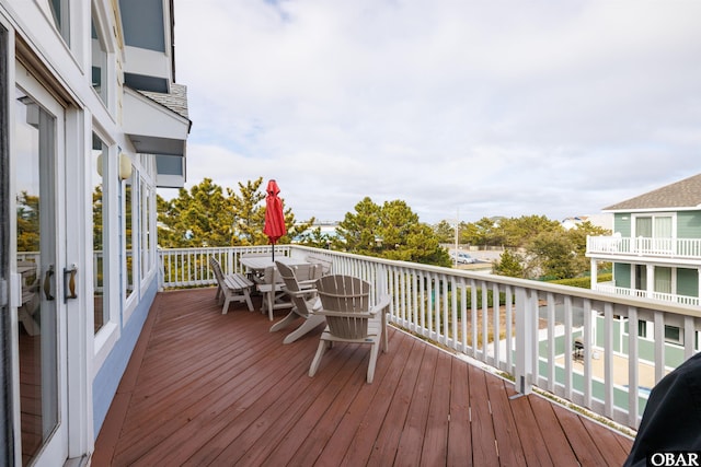 wooden terrace with outdoor dining area