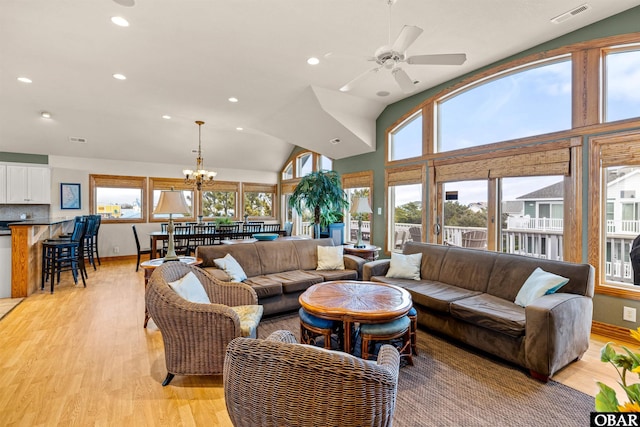 living area with ceiling fan with notable chandelier, recessed lighting, visible vents, and light wood-style floors