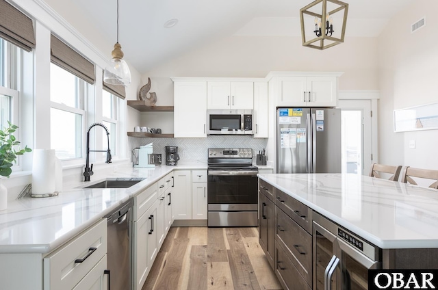 205 E Eckner St Lot # 17, Kitty Hawk, NC 27949 - kitchen featuring stainless steel appliances, a sink, open shelves, vaulted ceiling, and light wood-style flooring