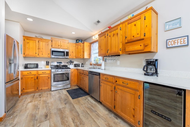 23180 Wimble Shores Dr Lot 8, Rodanthe, NC 27968 - kitchen featuring appliances with stainless steel finishes, wine cooler, vaulted ceiling, light countertops, and light wood-style flooring