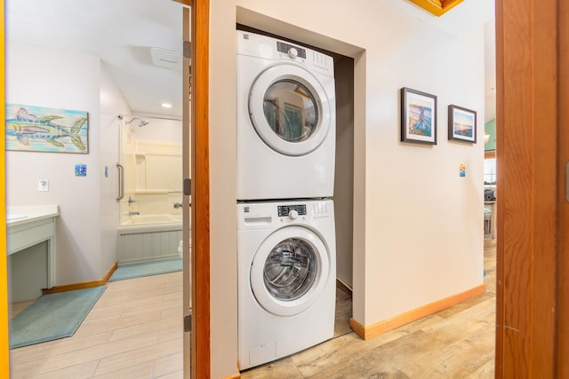 23180 Wimble Shores Dr Lot 8, Rodanthe, NC 27968 - clothes washing area with stacked washer and clothes dryer, baseboards, and light wood-type flooring