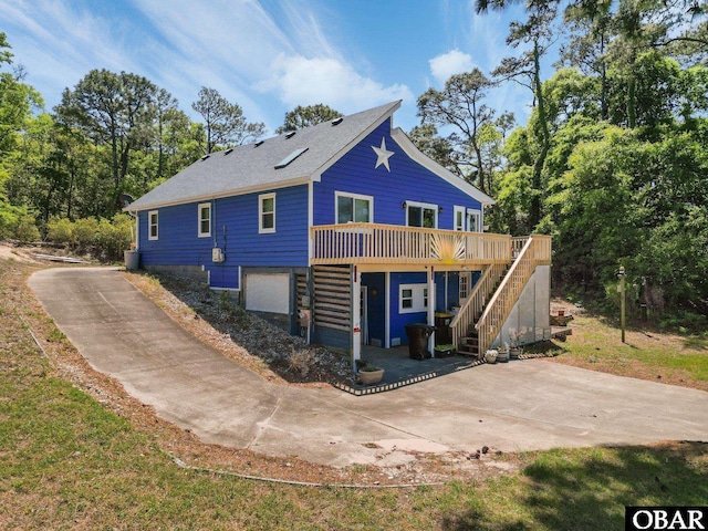 427 Harbour View Dr Unit Lot134-A, Kill Devil Hills, NC 27948 - back of property featuring stairs, a deck, and driveway