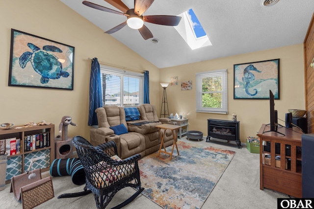 427 Harbour View Dr Unit Lot134-A, Kill Devil Hills, NC 27948 - living area featuring a skylight, a wood stove, vaulted ceiling, carpet, and ceiling fan