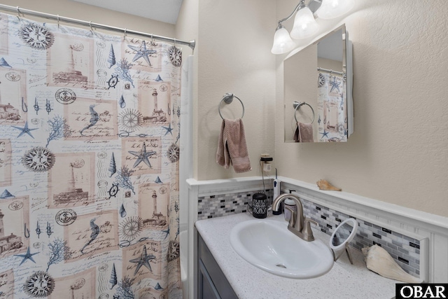 427 Harbour View Dr Unit Lot134-A, Kill Devil Hills, NC 27948 - full bathroom with vanity, decorative backsplash, and a shower with shower curtain