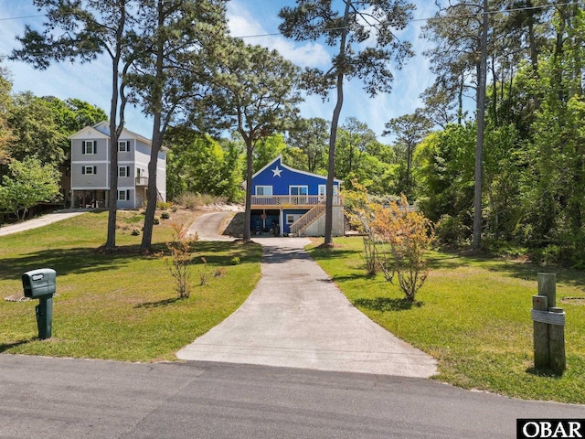 427 Harbour View Dr Unit Lot134-A, Kill Devil Hills, NC 27948 - surrounding community featuring concrete driveway, stairs, a yard, and a wooden deck