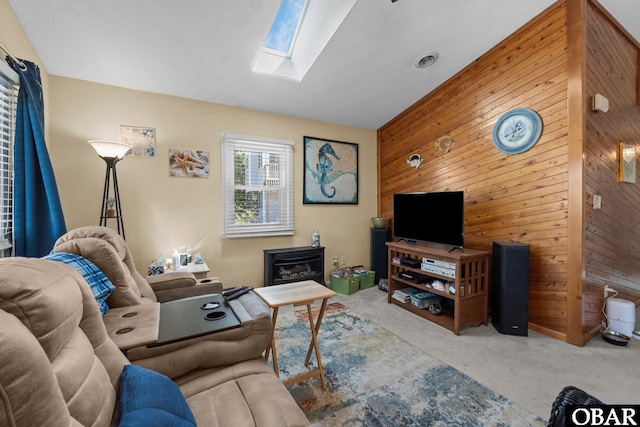 427 Harbour View Dr Unit Lot134-A, Kill Devil Hills, NC 27948 - living area featuring wood walls, carpet, a skylight, a wood stove, and an accent wall