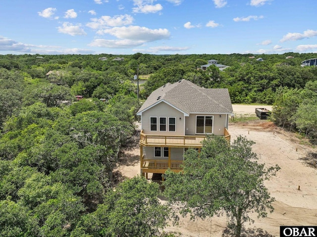 birds eye view of property with a view of trees