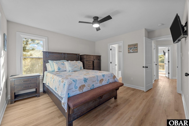 bedroom with ceiling fan, ensuite bathroom, light wood-type flooring, and baseboards