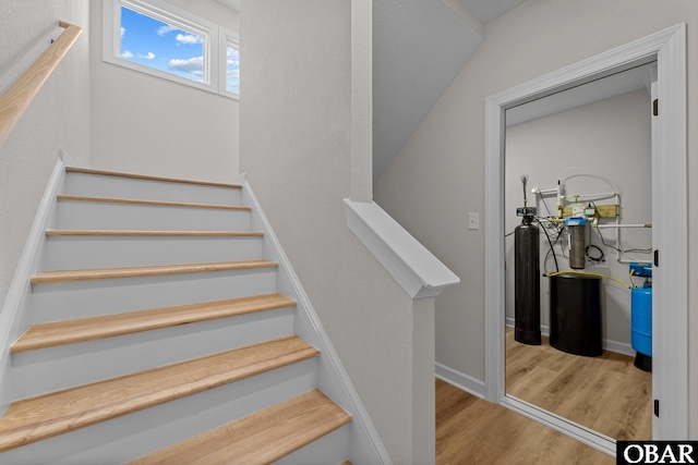 stairs with baseboards and wood finished floors