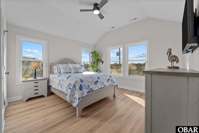 bedroom featuring visible vents, light wood-style flooring, baseboards, and lofted ceiling