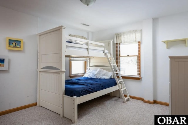 unfurnished bedroom featuring light carpet, visible vents, and baseboards