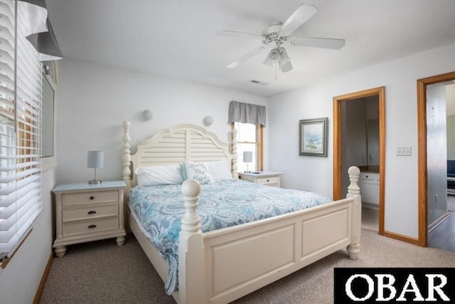 bedroom featuring ensuite bathroom, carpet floors, ceiling fan, and baseboards