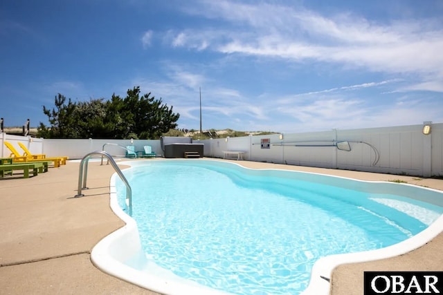 view of swimming pool with a fenced in pool, a fenced backyard, and a patio