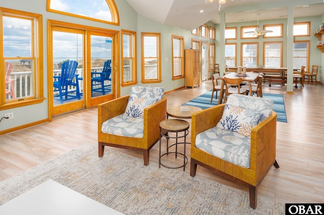 sunroom / solarium featuring lofted ceiling and ceiling fan