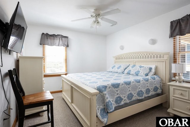 carpeted bedroom with ceiling fan and baseboards