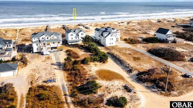 bird's eye view featuring a residential view, a water view, and a beach view