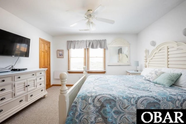 bedroom with light carpet, ceiling fan, and baseboards