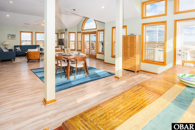 dining space featuring lofted ceiling, recessed lighting, light wood-style flooring, a ceiling fan, and baseboards