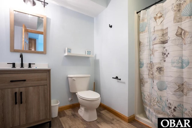 bathroom featuring toilet, vanity, wood finished floors, a shower with curtain, and baseboards