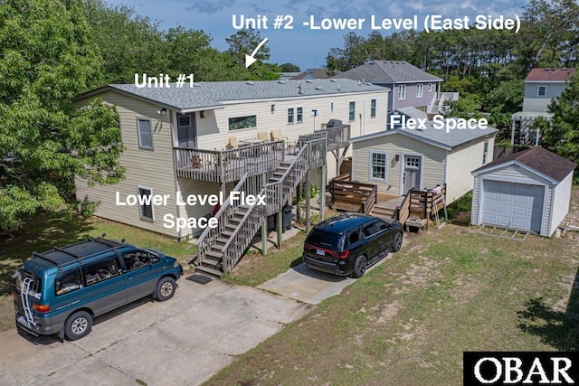 view of front of property featuring an outdoor structure, stairs, concrete driveway, a deck, and a detached garage