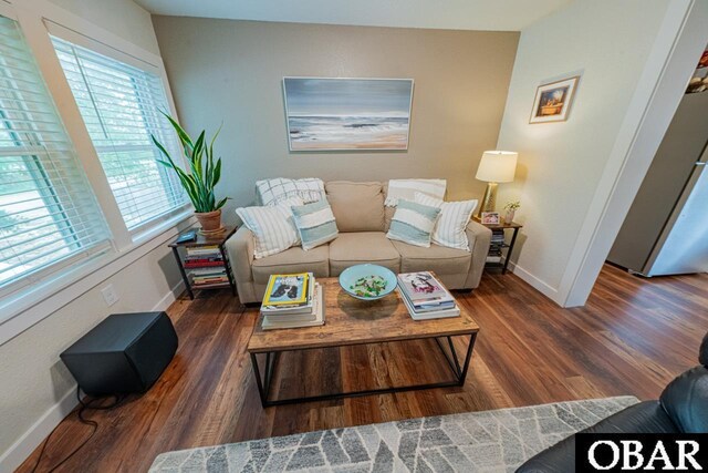living area featuring baseboards and wood finished floors