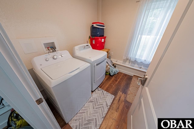 washroom with washer and dryer and wood finished floors