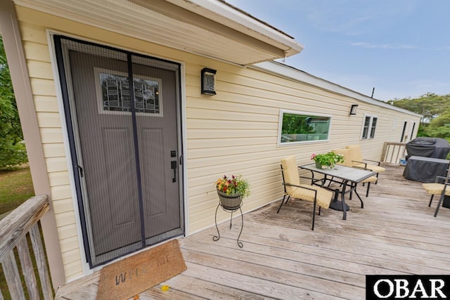 wooden terrace with outdoor dining area