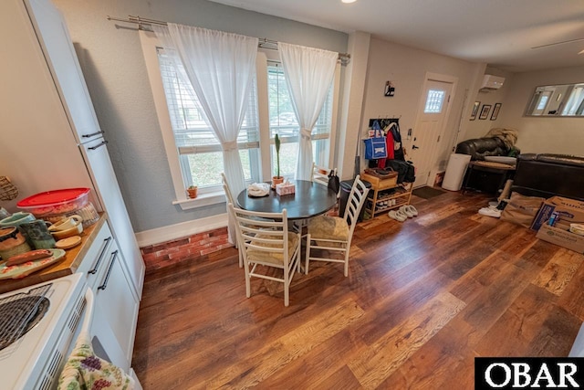dining space with wood finished floors and plenty of natural light